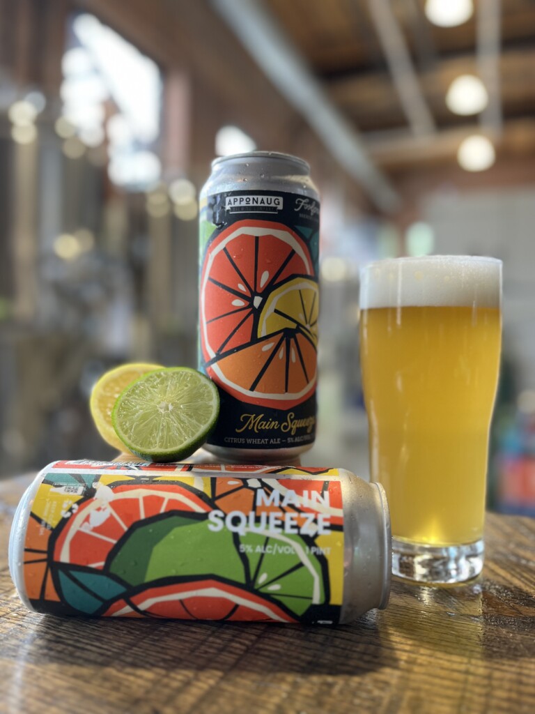 A brightly colored can featuring images of oranges, limes and lemon.